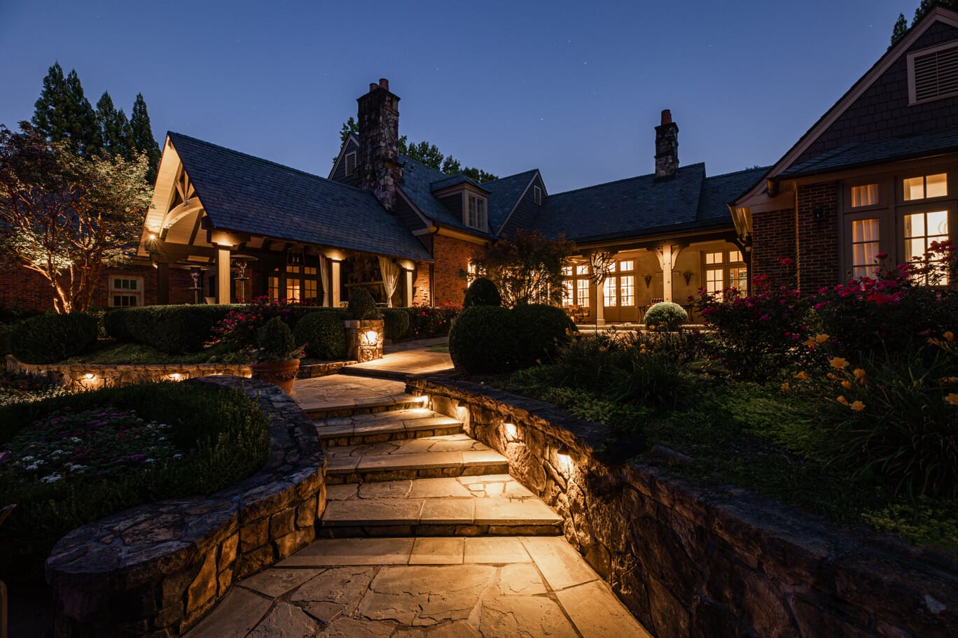 large home with outdoor lighting